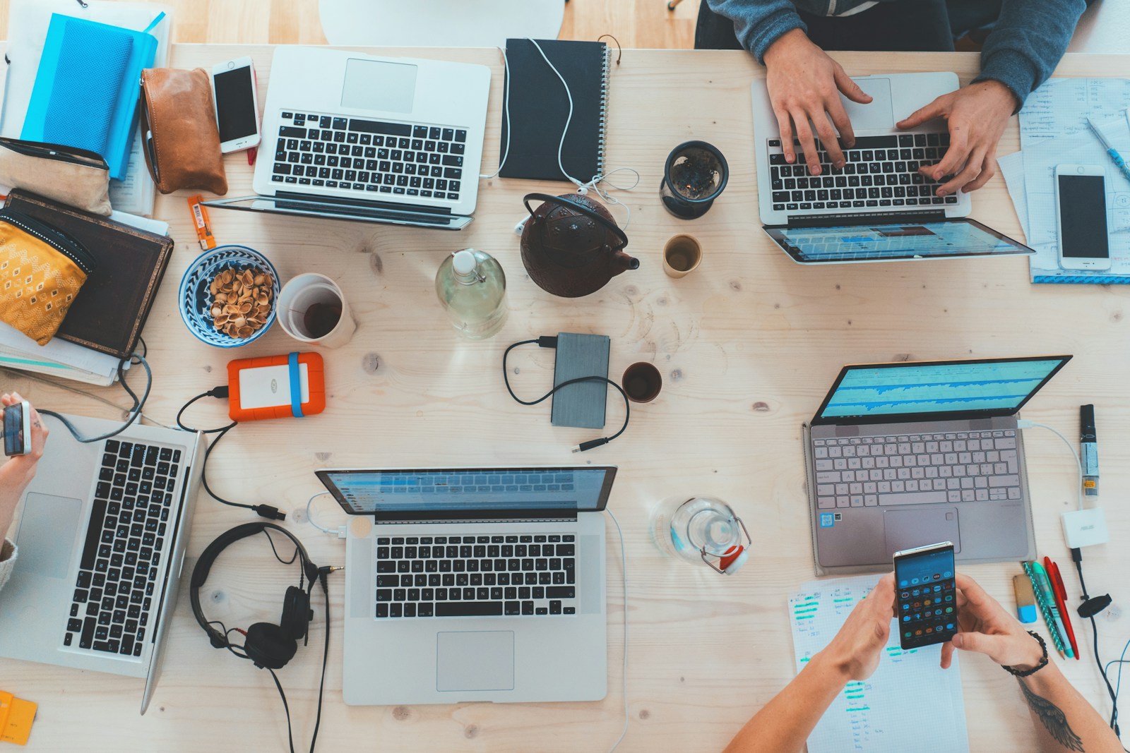 Professionals working at laptops in a modern office